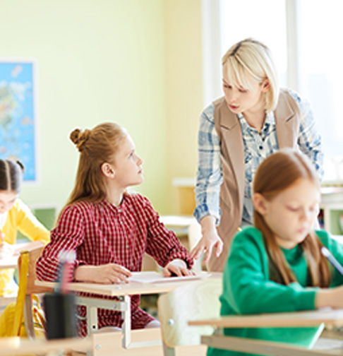 Teacher help their kids in a classroom Educator help students in a classroom