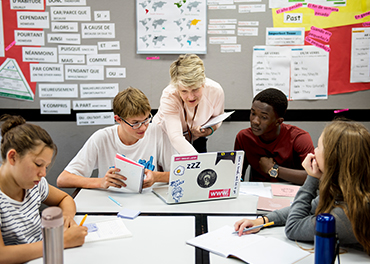 Teacher help students in education in a school